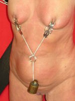 Nipple tortured with clamps and weights