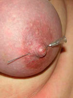 Needles through her nipples