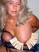 Mature blonde with clothespins on tits